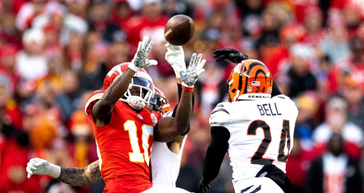 Cincinnati Bengals free safety Jessie Bates (30) knocks the ball away from Kansas City Chiefs wide receiver Tyreek Hill (10) and Cincinnati Bengals safety Vonn Bell (24) intercepts it in overtime of the AFC championship NFL football game, Sunday, Jan. 30, 2022, at GEHA Field at Arrowhead Stadium in Kansas City, Mo. Cincinnati Bengals defeated Kansas City Chiefs 27-24. Cincinnati Bengals At Kansas City Chiefs Jan 30 Afc Championship 103